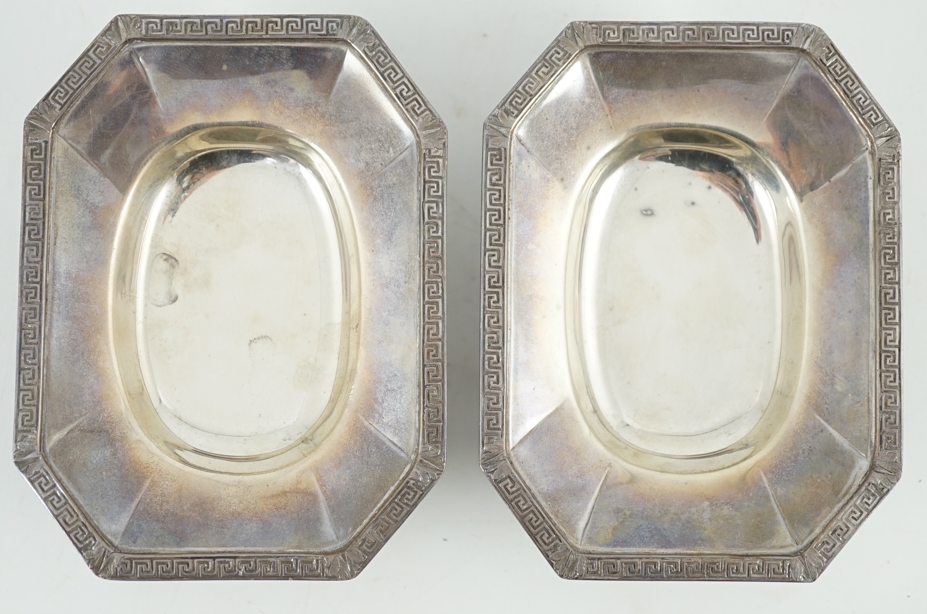 A pair of George V silver salt cellars, with cut glass liners